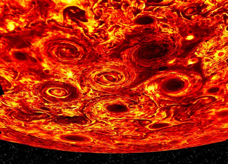 Jupiter’s south pole as seen at 5 µm wavelength, showing heat emanating from the planet through the clouds (the darker the color, the thicker the clouds).